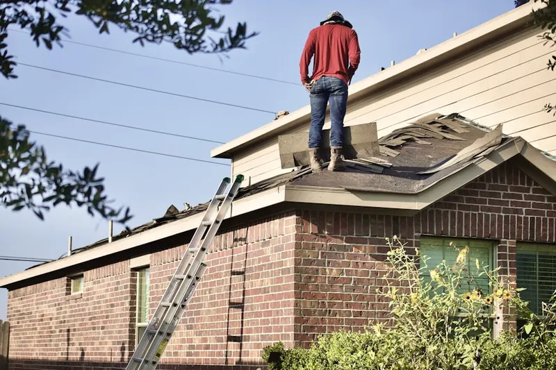 Professional roofer working on a residential roof in Derringer Corners
